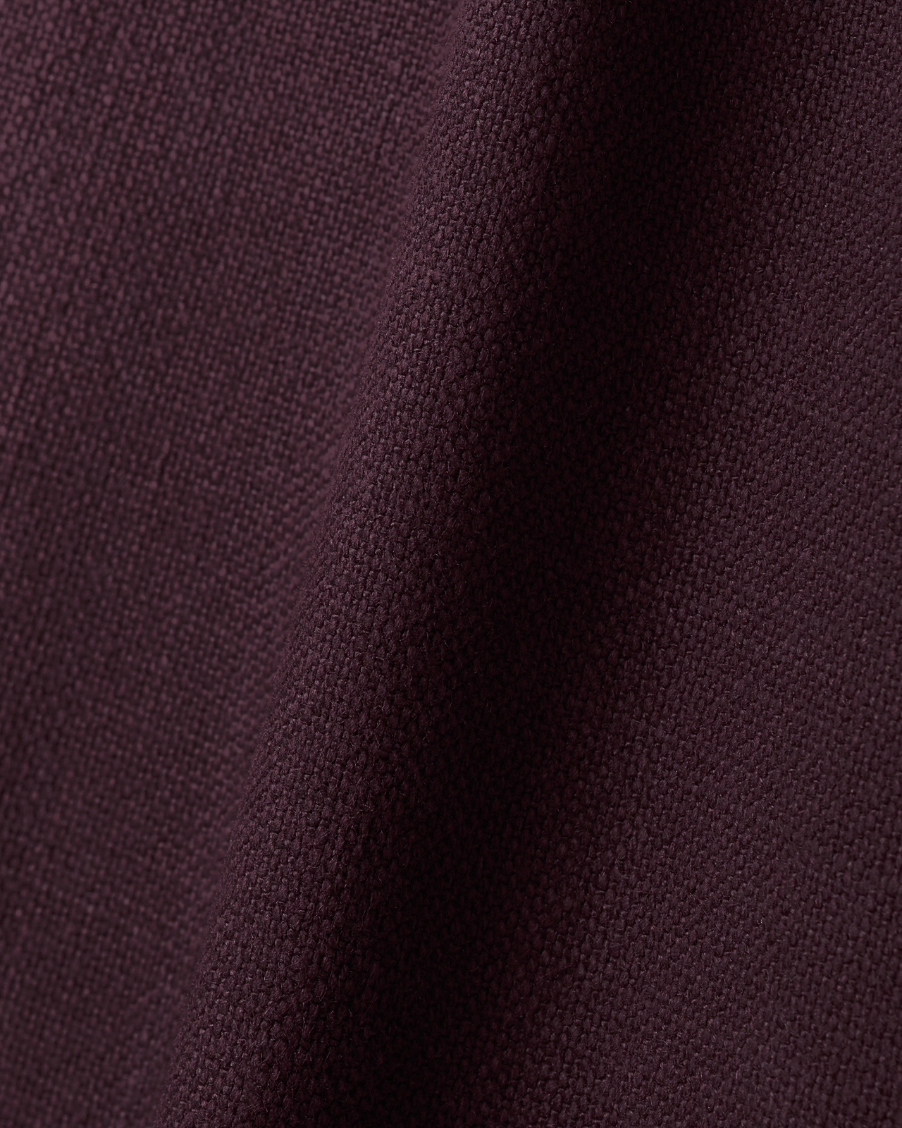 Close-up of the Studio Linen fabric in Deep Wine, showing its plain red linen weave.
