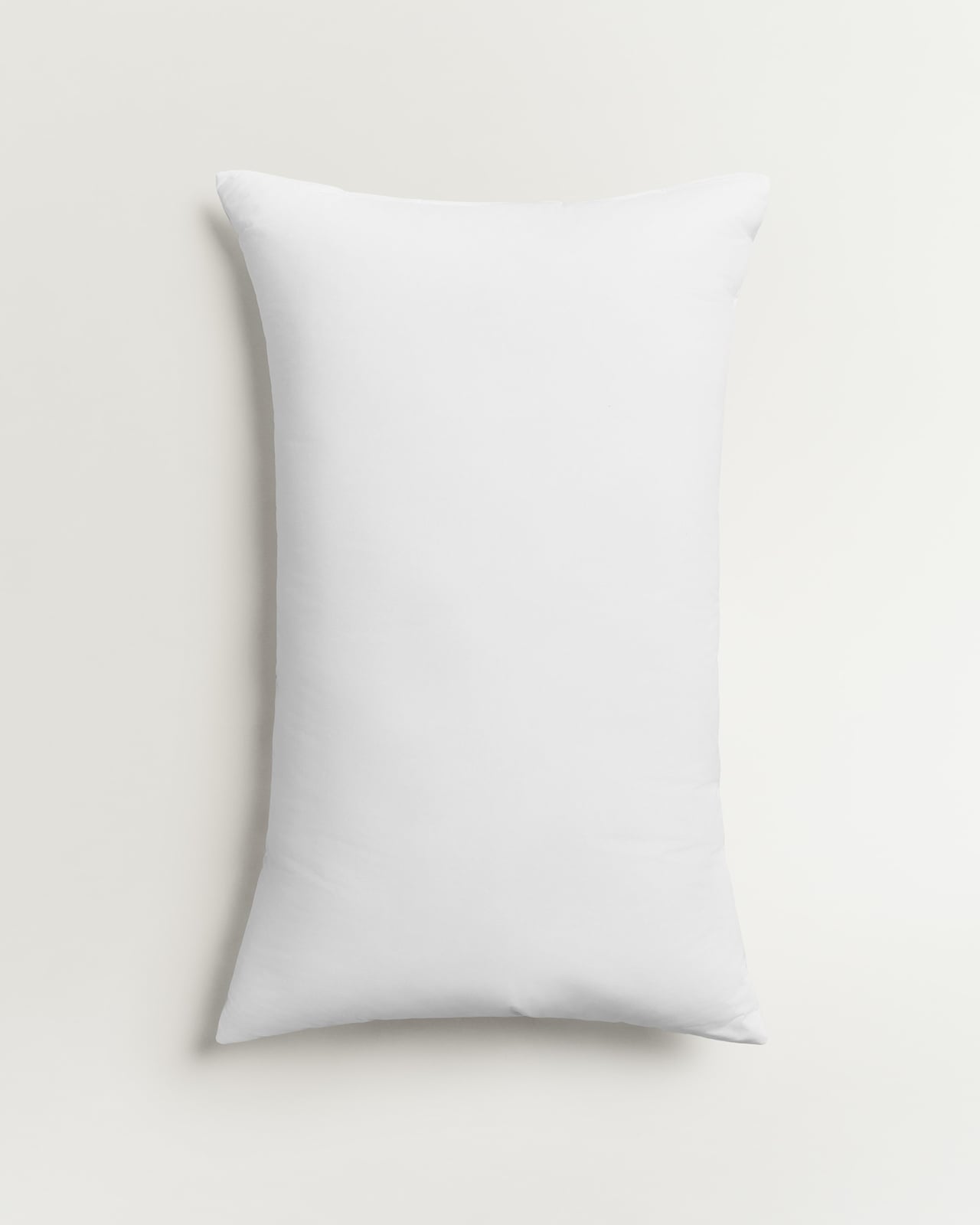 Down and Feather Pillow in White, a crisp white cotton pillow with a smooth finish.