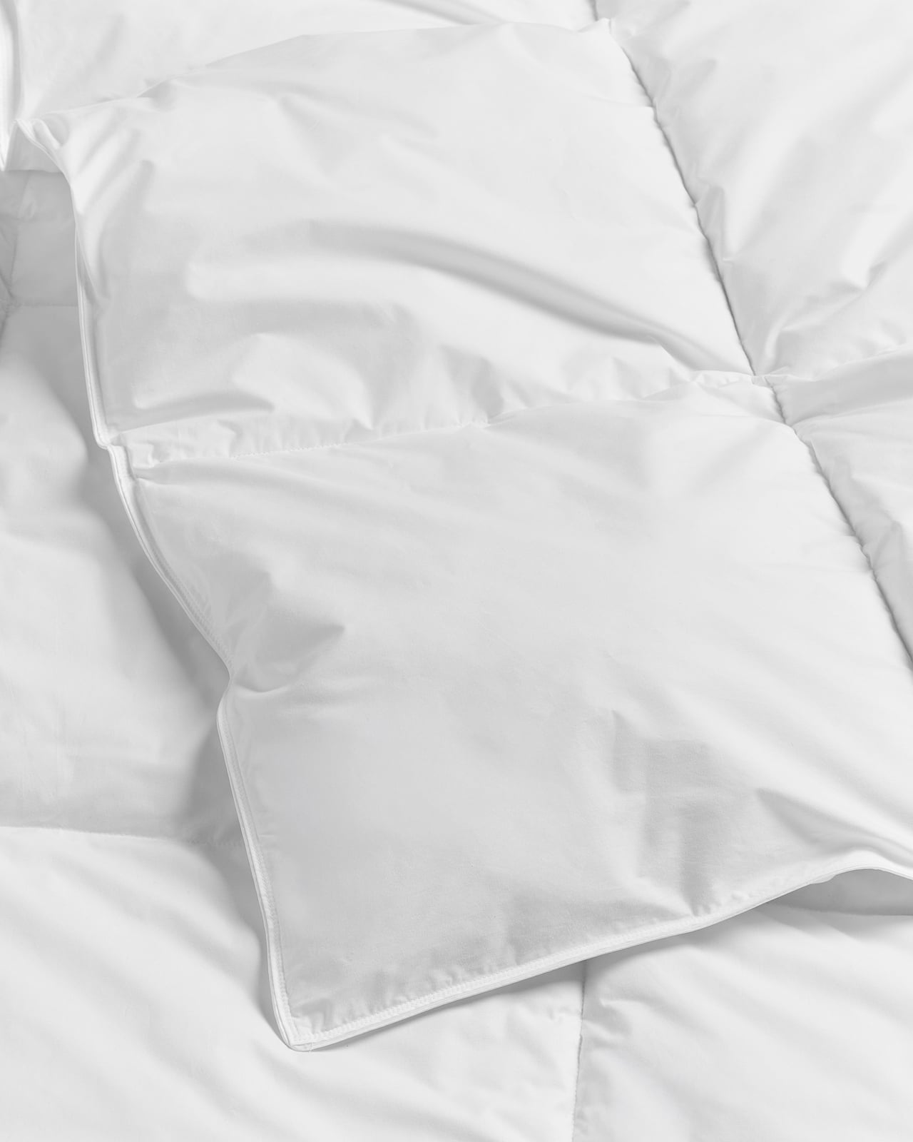 Down Alternative Duvet – Medium in White, a folded white duvet with a stitched grid pattern.