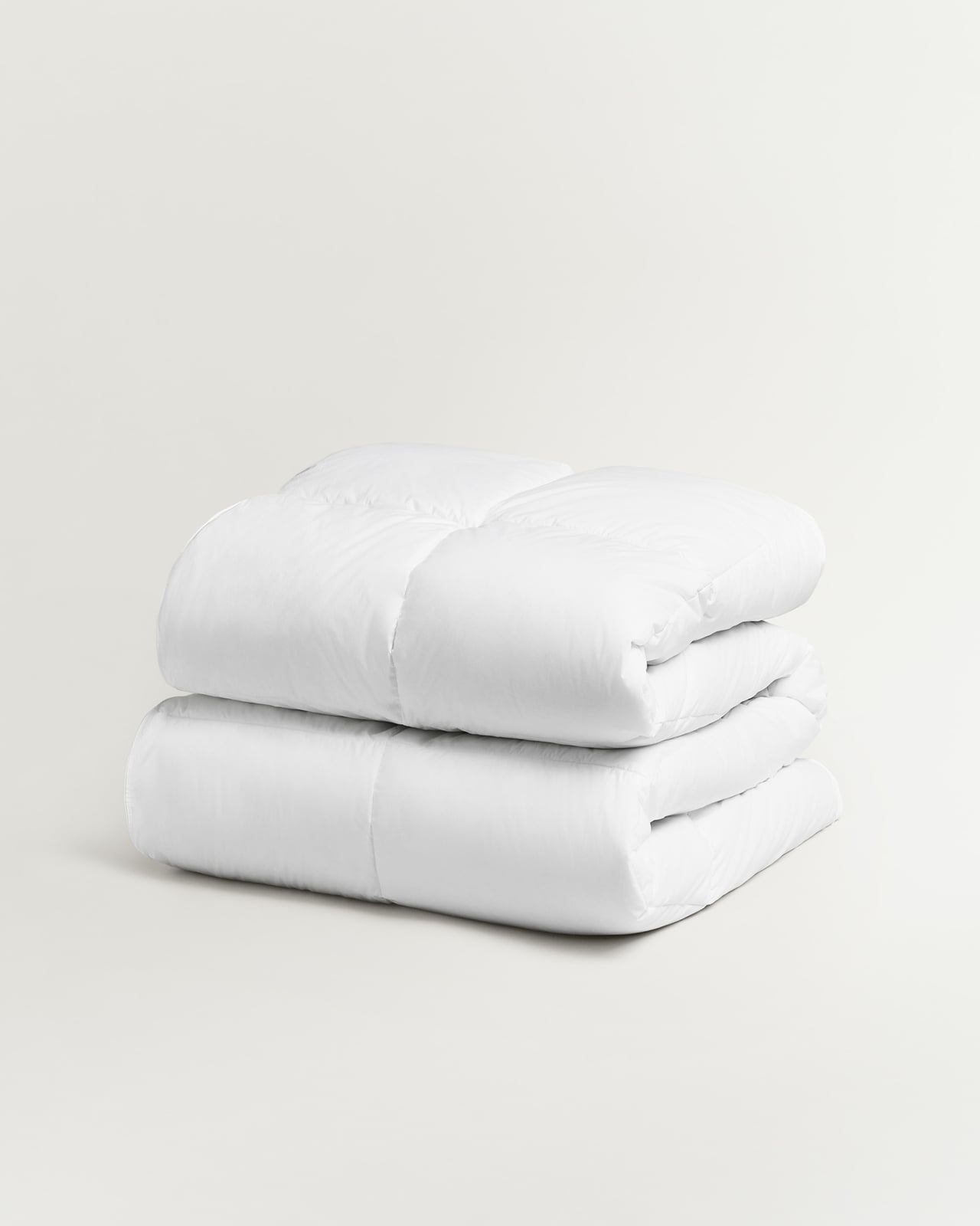 Down Alternative Duvet – Medium in White, a folded white duvet with a stitched grid pattern.