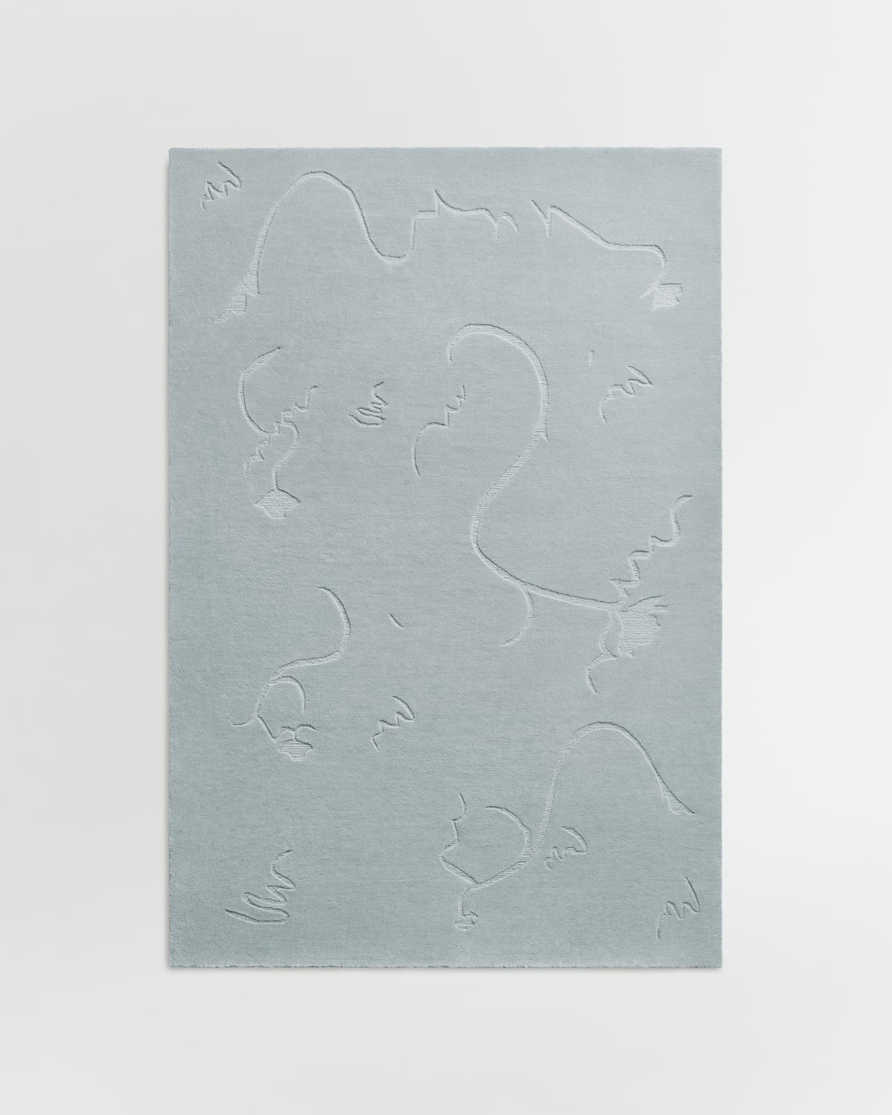 Dancing Flower in Dusty Blue - a plush wool rug with a subtle organic floral pattern.