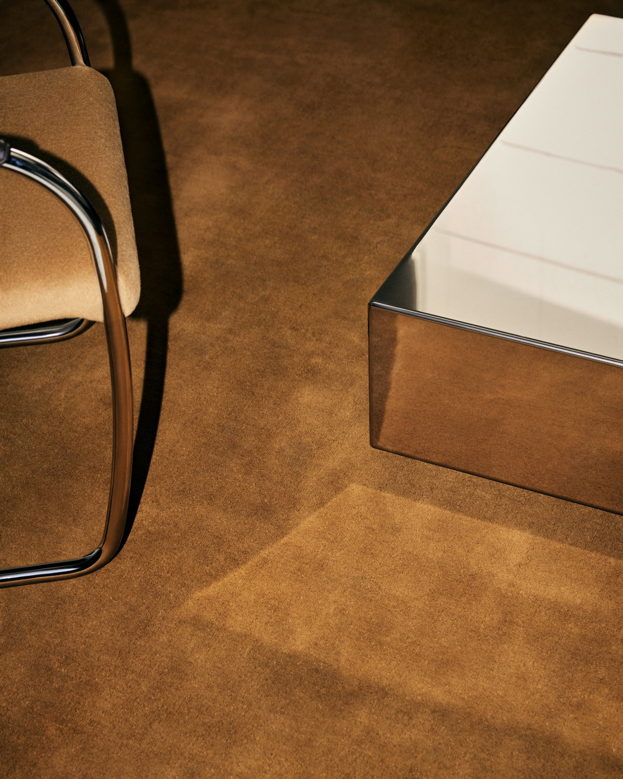 Close-up of the Grand rug in Pecan, showing its smooth cut pile surface and bound edge in a warm earthy brown tone.