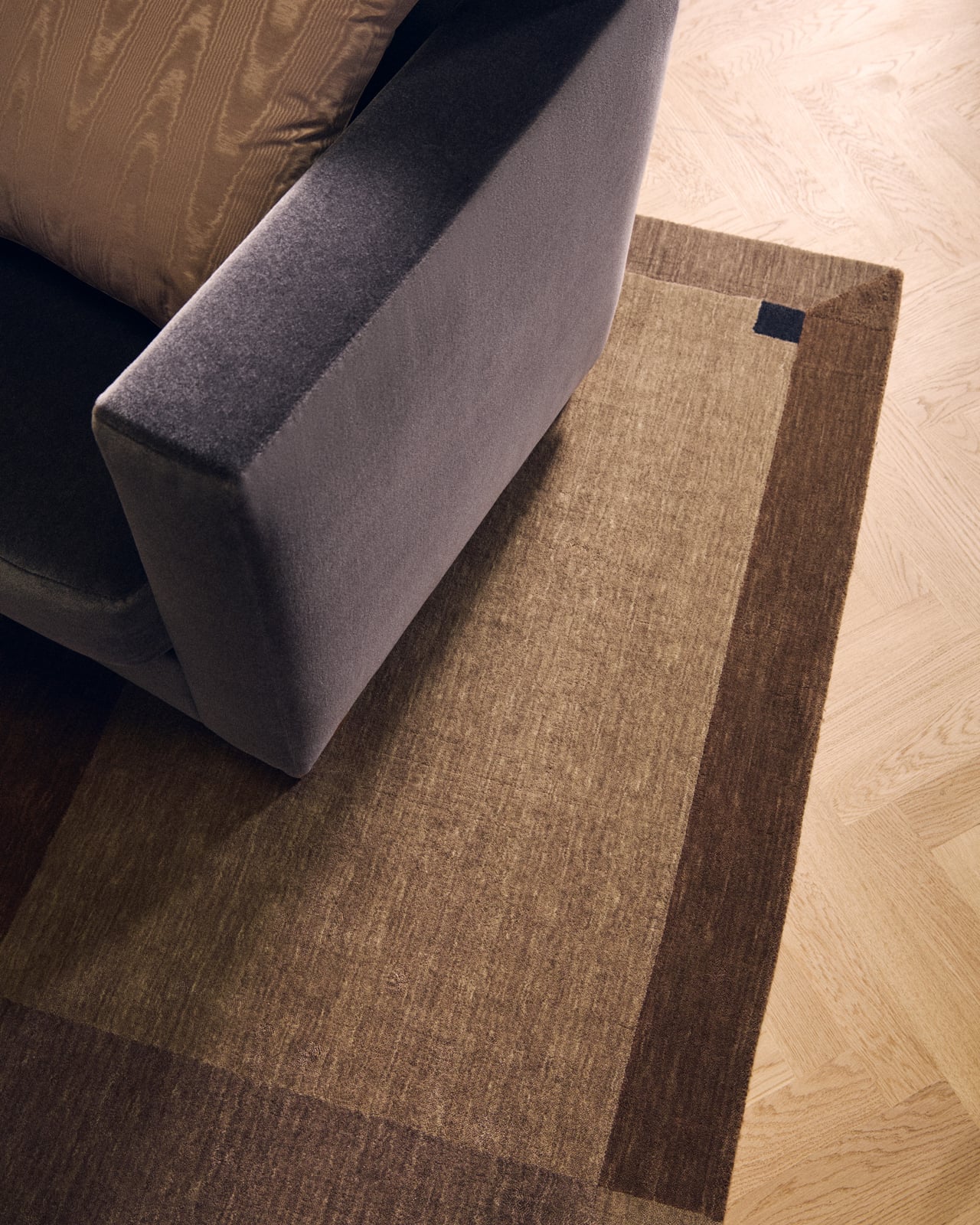 Parchment in Brown - a rug featuring geometric color-blocked rectangles in earthy brown tones with dark corner details.