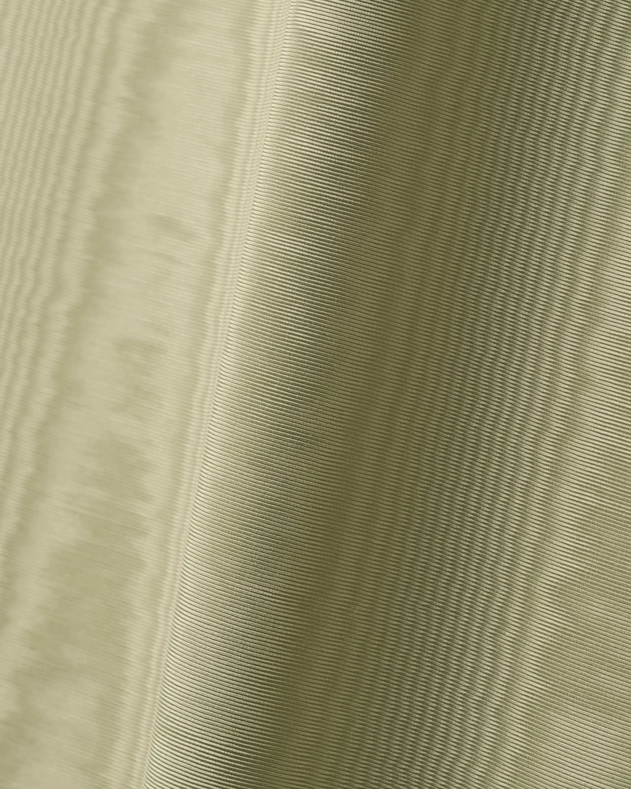 Close-up of Fabric by the yard - The Moire - Pistachio, showing the textured moire pattern in a soft silvery green tone.