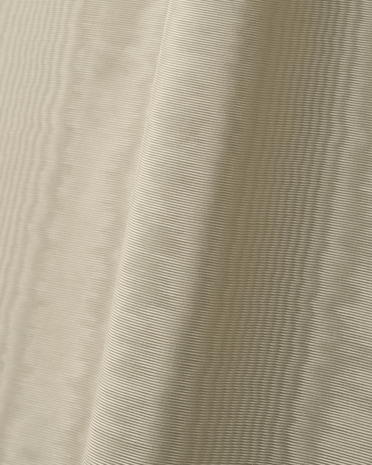 Close-up of The Moire fabric in Sand, showing the characteristic moiré pattern and smooth polyester weave.